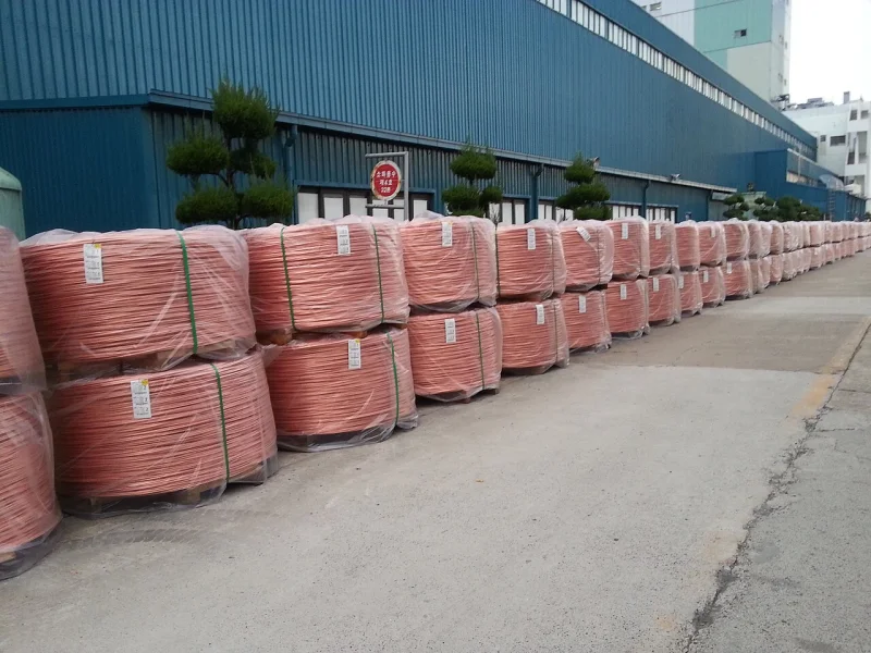 Large coils of copper wire rod stacked for industrial handling